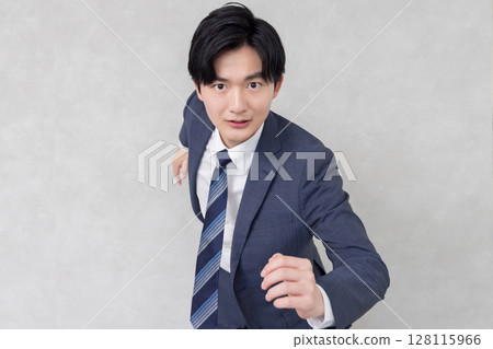 Young businessman running Young businessman running 128115966