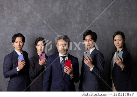 Business people of various generations using smartphones Business people of various generations using smartphones 128115987