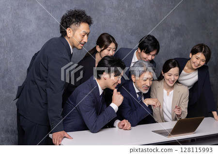 Several businessmen checking business results 128115993