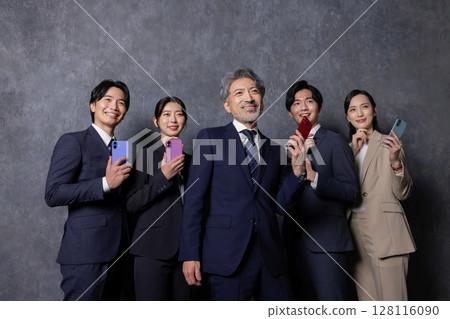 Business people of various generations using smartphones 128116090