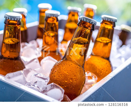 Close-up of a sizzling beer with water droplets 128116316