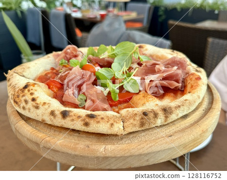 delicious juicy pizza in a cafe on a table. High quality photo delicious juicy pizza in a cafe on a table. High quality photo 128116752