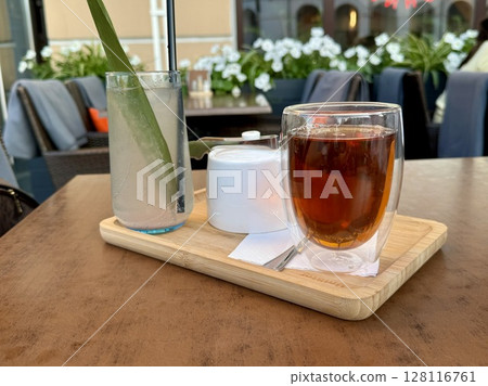 A cup of tea and lemonade are on a table in a summer cafe. High quality photo 128116761
