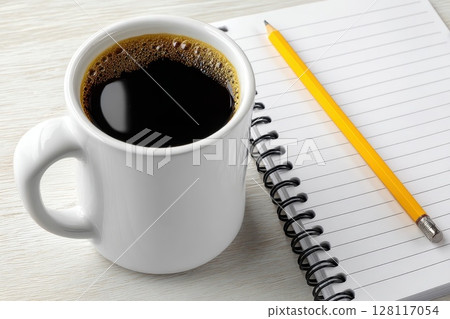 Overhead View of Workspace Featuring Coffee, Notebook, and Pencil on Light Background Overhead View of Workspace Featuring Coffee, Notebook, and Pencil on Light Background 128117054