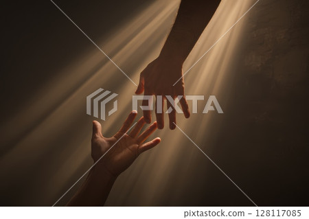 Two Hands Barely Touching in a Beam of Light, Symbolizing Connection and Hope 128117085
