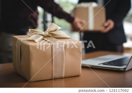 Elegant Gift Package Presented in a Corporate Lounge Area for Professional Moments and Celebrations Elegant Gift Package Presented in a Corporate Lounge Area for Professional Moments and Celebrations 128117092