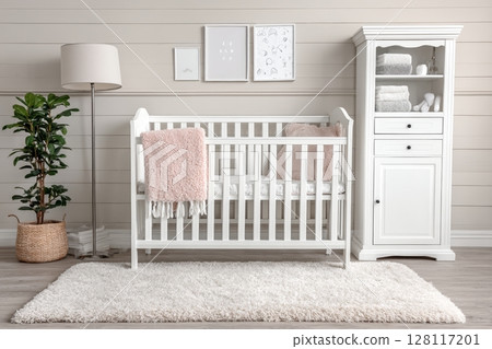A children's room interior includes a baby bed with a stylish appearance located adjacent to a light wall 128117201