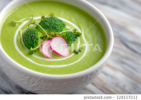 A flat lay composition featuring a bowl of broccoli cream soup positioned on a white marble table A flat lay composition featuring a bowl of broccoli cream soup positioned on a white marble table 128117211