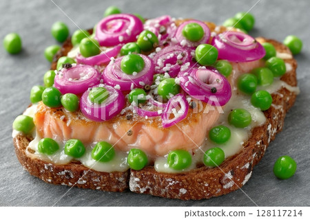 Dark rye bread serves as the base for toast topped with avocado, cucumber, and smoked salmon Dark rye bread serves as the base for toast topped with avocado, cucumber, and smoked salmon 128117214