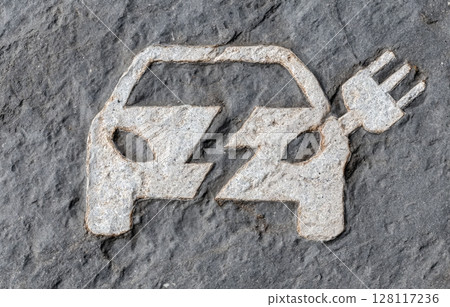 A painted road sign marks the parking spot for recharging electric vehicles A painted road sign marks the parking spot for recharging electric vehicles 128117236
