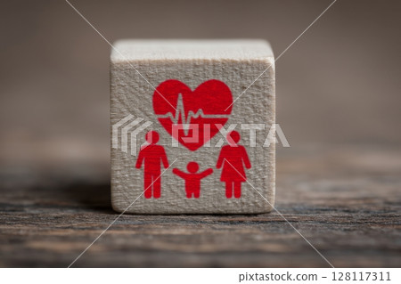 The idea of healthcare insurance is represented by a hand stacking wooden blocks accompanied by a medical icon 128117311