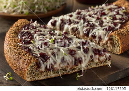 A homemade pizza with mixed microgreens and feta, photographed in a horizontal close-up format 128117395