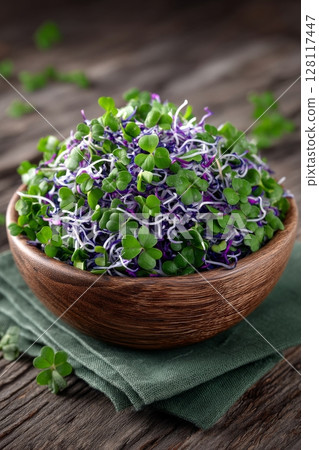 A close-up vertical view from the top of homemade fresh microgreens including peas, cilantro, mustard, and radish on a plate 128117447