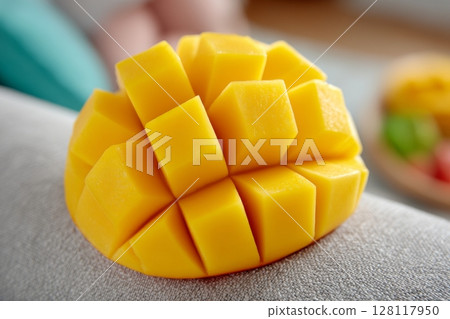 A toddler infant is being fed mango by father using a spoon 128117950