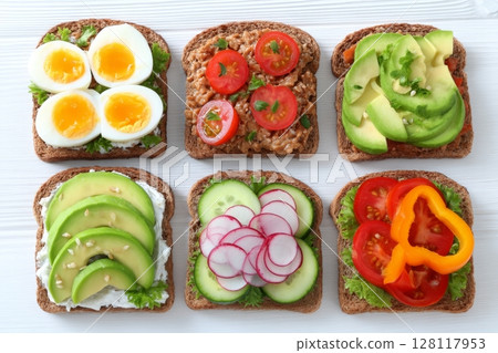 On white wood, a range of wholesome vegetarian sandwiches is showcased in a top view arrangement On white wood, a range of wholesome vegetarian sandwiches is showcased in a top view arrangement 128117953