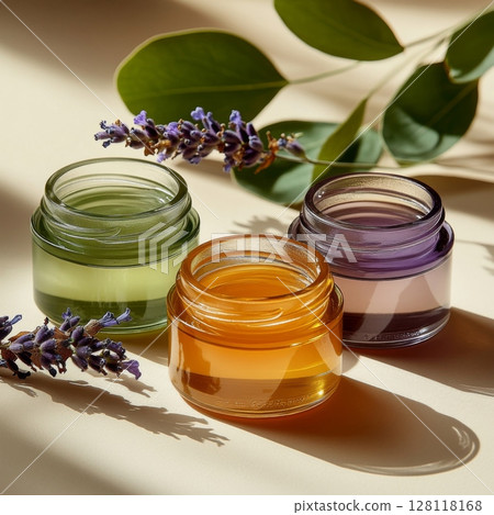 Natural cosmetics for organic facial care featuring vibrant jars filled with nourishing blends for skincare, displayed alongside fresh lavender and green leaves Natural cosmetics for organic facial care featuring vibrant jars filled with nourishing blends for skincare, displayed alongside fresh lavender and green leaves 128118168