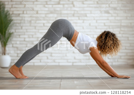 Image of attractive female performing donkey kick exercise Image of attractive female performing donkey kick exercise 128118254