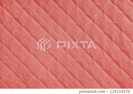 Checkered, diamond stitching pattern, red quilted fabric background. Blanket stitch texture 128119370