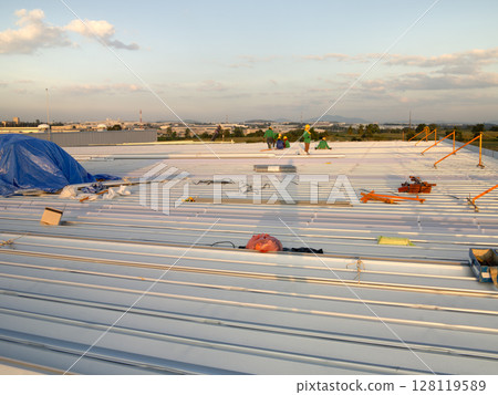 Metal roof sheet installation or construction for factory warehouse. 128119589