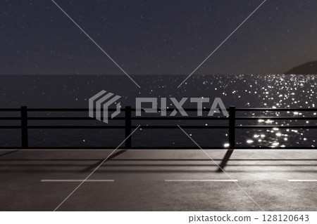 A seaside road with guardrails at night with moonlight reflecting off the sparkling sea surface 128120643