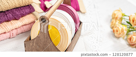 Colored ribbons and lace in coils for hobbies 128120877