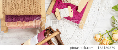 Colored ribbons and lace in coils for hobbies 128120879