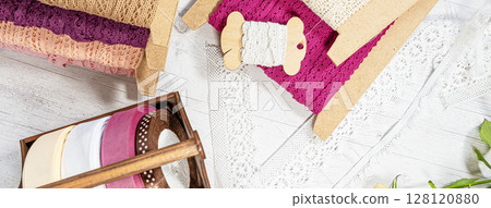 Colored ribbons and lace in coils for hobbies 128120880