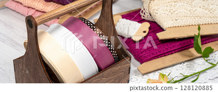 Colored ribbons and lace in coils for hobbies 128120885