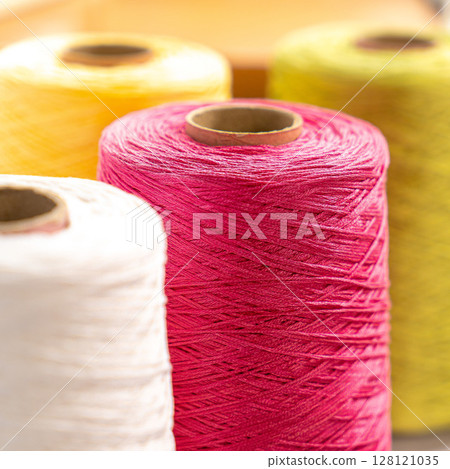 Threads in reels. Colored bobbins for embroidery knitting hobby accessories creativity. Threads in reels. Colored bobbins for embroidery knitting hobby accessories creativity. 128121035