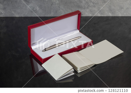 Fountain pen with box on dark gray background. Stationery branded items Fountain pen with box on dark gray background. Stationery branded items 128121110