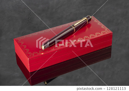 Fountain pen with box on dark gray background. Stationery branded items Fountain pen with box on dark gray background. Stationery branded items 128121113