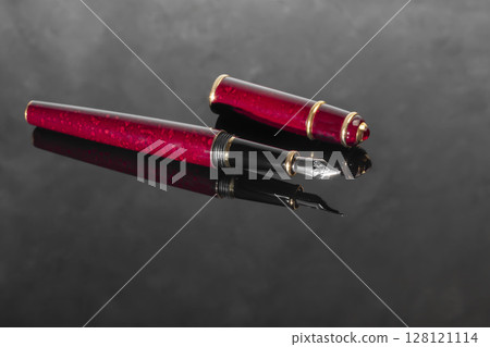 Fountain pen with box on dark gray background. Stationery branded items 128121114