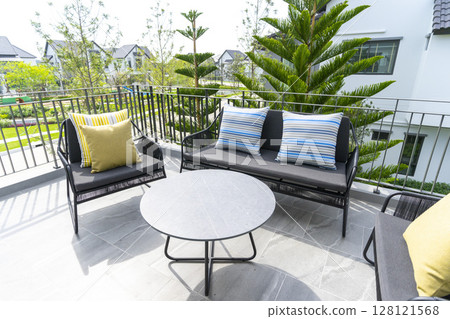 Modern luxury outdoor sofas and a set table and comfortable pillow on a private porch. 128121568