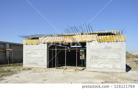 construction of a new garage. the building is missing a gate and a roof construction of a new garage. the building is missing a gate and a roof 128121769