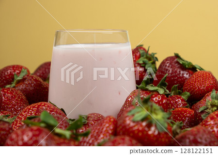 Milk drinking strawberry yogurt in a glass. Milk drinking strawberry yogurt in a glass. 128122151