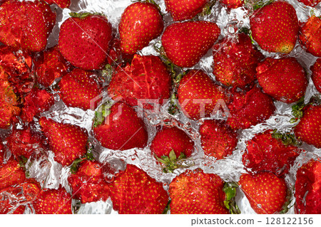 Ripe whole strawberry in water, berry splash, summer background, top view Ripe whole strawberry in water, berry splash, summer background, top view 128122156