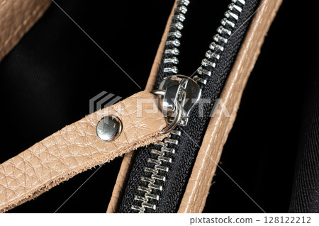 Metal zipper on the inside pocket of the leather bag. Metal zipper on the inside pocket of the leather bag. 128122212