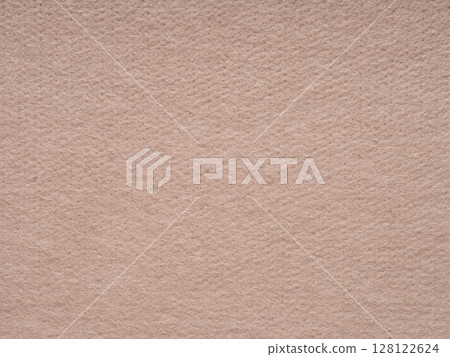 A close-up of a warm beige felt surface that evokes a soft and comforting tactile sensation, with a subtle and homely visual style 128122624