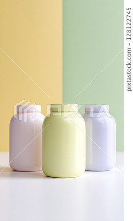 Three identical jars in pastel colors are arranged on a clean surface against a backdrop of soft yellow and green walls, providing a modern aesthetic Three identical jars in pastel colors are arranged on a clean surface against a backdrop of soft yellow and green walls, providing a modern aesthetic 128122745
