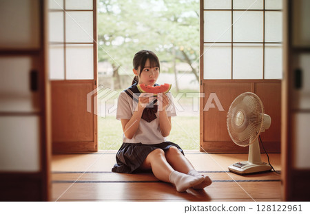 High school girl eating watermelon 128122961