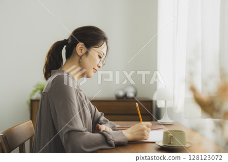 一位女士在家中的辦公桌前 128123072