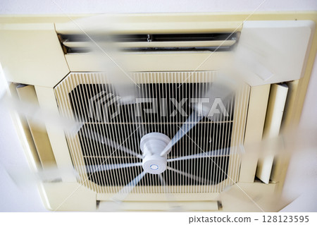 Ceiling air conditioners and fans in offices 128123595