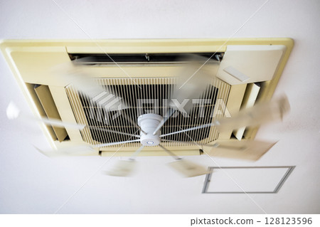 Ceiling air conditioners and fans in offices 128123596