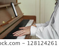 An Elegant Piano Performance Featuring Sheet Music Display Enhancing the Musical Experience 128124261