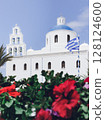 Blue dome church and flowers in Oia, Santorini 128124600