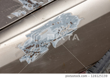 Car part with removed paint. grinding paint from surface with mechanical method Car part with removed paint. grinding paint from surface with mechanical method 128125139