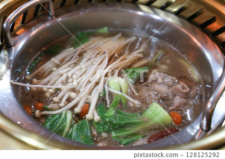 Sukiyaki ,suki or shabu pot and sliced beef or vegetable soup in the pot Sukiyaki ,suki or shabu pot and sliced beef or vegetable soup in the pot 128125292