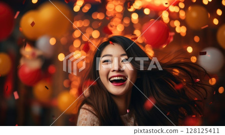 Asian woman celebrating new year eve on a blurred holiday background 128125411