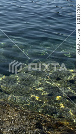 Top-Down View of Sea Rocks Under Clear Water 128125580