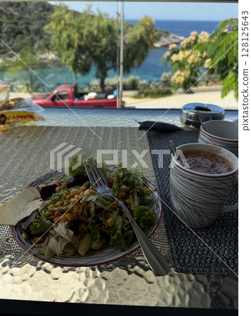 Greek Dish and Cold Drink on Seaside Table Greek Dish and Cold Drink on Seaside Table 128125643
